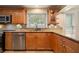 Close up of a traditional kitchen featuring wooden cabinets, stainless steel appliances, and a window with natural light at 5512 Avenida Del Mare, Sarasota, FL 34242