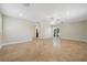 Large living room with tile floors, neutral walls, a ceiling fan, and access to a small balcony at 5512 Avenida Del Mare, Sarasota, FL 34242