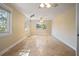 Bright living room with travertine tile floors, ceiling fan, and natural light streaming through the windows at 5512 Avenida Del Mare, Sarasota, FL 34242