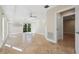 Bright living room with tile floors, ceiling fan, and access to a private balcony showcasing lush greenery at 5512 Avenida Del Mare, Sarasota, FL 34242