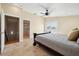 Spacious main bedroom with tile flooring, ceiling fan, and a door to a walk-in closet at 5512 Avenida Del Mare, Sarasota, FL 34242
