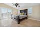 Main bedroom with tile flooring, a ceiling fan, and large windows at 5512 Avenida Del Mare, Sarasota, FL 34242