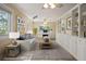 Bright home office featuring custom built-in bookshelves, a large desk, and comfortable seating, perfect for remote work at 5512 Avenida Del Mare, Sarasota, FL 34242