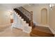 Elegant staircase featuring wood steps, wrought iron railing, and built-in shelving, adding character to the home's interior at 5512 Avenida Del Mare, Sarasota, FL 34242