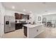 Open concept kitchen with stainless steel appliances, large island, and adjacent dining area at 5708 Bannock Cir, North Port, FL 34288