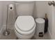 Close-up of a white toilet with a silver toilet paper holder and a gray trash can next to it at 5708 Bannock Cir, North Port, FL 34288