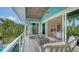 Outdoor balcony with a stone ceiling and modern seating area that leads into the home's interior at 5930 Briarwood Ave, Sarasota, FL 34231