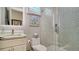 Elegant bathroom featuring a glass shower with decorative tile, a marble countertop, and stylish fixtures at 5930 Briarwood Ave, Sarasota, FL 34231