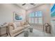 Cozy bedroom with comfortable sofa, shuttered windows, neutral decor and a bright sunny ambiance at 5930 Briarwood Ave, Sarasota, FL 34231