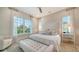 Bright bedroom with neutral decor, large windows, and a cozy armchair at 5930 Briarwood Ave, Sarasota, FL 34231