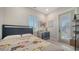 Bedroom features light floors, a window with plantation shutters, and access to a balcony at 5930 Briarwood Ave, Sarasota, FL 34231