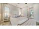 Stylish bedroom features lots of natural light, neutral decor, and an attached bathroom at 5930 Briarwood Ave, Sarasota, FL 34231