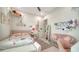 Comfortable bedroom with a cozy pink couch, whimsical decor, and natural light at 5930 Briarwood Ave, Sarasota, FL 34231