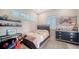 Comfortable bedroom featuring a bed, bright windows, a dresser, and themed decor with colorful accents at 5930 Briarwood Ave, Sarasota, FL 34231