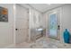 Well-lit entryway showcasing stylish console table, contemporary decor, and elegant flooring creating a welcoming ambiance at 5930 Briarwood Ave, Sarasota, FL 34231