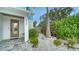 Close-up of the home's front entrance, featuring a stone walkway and decorative landscaping at 5930 Briarwood Ave, Sarasota, FL 34231