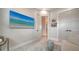 Bright hallway features an open doorway and clean, modern design and decor, including wall-mounted art at 5930 Briarwood Ave, Sarasota, FL 34231