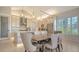 Gourmet kitchen featuring a large island, stainless steel appliances, custom cabinets, and an open dining area at 5930 Briarwood Ave, Sarasota, FL 34231