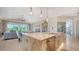 Bright kitchen featuring marble countertops, farmhouse sink, modern lighting and a seamless flow to the living spaces at 5930 Briarwood Ave, Sarasota, FL 34231