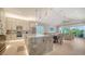 Open-concept kitchen boasts marble countertops, stainless steel appliances, and a seamless flow into the dining and living areas at 5930 Briarwood Ave, Sarasota, FL 34231