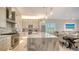 Modern kitchen featuring a marble island, chef-grade appliances, and seamless integration with the dining space at 5930 Briarwood Ave, Sarasota, FL 34231