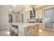 Bright kitchen boasting a marble island, stainless appliances, white cabinetry, and bar stool seating at 5930 Briarwood Ave, Sarasota, FL 34231