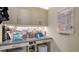 Organized home office with built-in desk, storage, and workspace illuminated by built-in lighting at 5930 Briarwood Ave, Sarasota, FL 34231