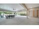 Expansive covered patio features sliding glass doors, a dining area, and an unfinished room perfect for customization at 5930 Briarwood Ave, Sarasota, FL 34231