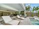 Inviting outdoor living space featuring a pool, lounge chairs, and lush tropical landscaping for ultimate relaxation at 5930 Briarwood Ave, Sarasota, FL 34231