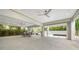 Spacious covered patio features an outdoor dining area and a relaxing lounge space overlooking the pool and tropical landscaping at 5930 Briarwood Ave, Sarasota, FL 34231