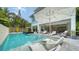 A stunning pool is surrounded by lounge chairs and umbrellas, offering a luxurious outdoor experience at 5930 Briarwood Ave, Sarasota, FL 34231