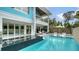 Backyard pool and an open floor plan with lounge chairs and sun umbrellas, perfect for relaxation at 5930 Briarwood Ave, Sarasota, FL 34231