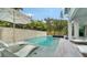 Beautiful backyard pool with lush landscaping and stone wall, offers a serene and private outdoor experience at 5930 Briarwood Ave, Sarasota, FL 34231