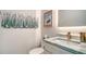 Powder room featuring a unique vanity with a marble countertop and stylish décor at 5930 Briarwood Ave, Sarasota, FL 34231