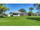 Expansive backyard featuring lush green grass and a screened lanai, perfect for outdoor living at 626 Magellan Dr, Sarasota, FL 34243