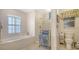 Full bathroom includes a soaking tub, walk-in shower, toilet, and decorative towels at 626 Magellan Dr, Sarasota, FL 34243