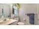 A clean half bath has a sink, toilet, and view to the outside from a small window at 626 Magellan Dr, Sarasota, FL 34243