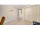Empty bedroom has a carpeted floor, double closet and a white wall at 626 Magellan Dr, Sarasota, FL 34243