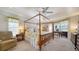 Elegant bedroom with four-poster bed, carpet floors, ceiling fan, and floral curtains at 626 Magellan Dr, Sarasota, FL 34243