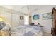 Guest bedroom features a closet, ceiling fan, and wall-mounted TV, with carpet flooring at 626 Magellan Dr, Sarasota, FL 34243