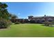 Exterior view of building with beautiful landscaping and green lawn at 626 Magellan Dr, Sarasota, FL 34243