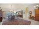 Elegant dining room with a chandelier, wooden table, and a patterned rug at 626 Magellan Dr, Sarasota, FL 34243
