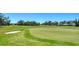 Scenic view of the well-maintained golf course, showcasing the green and a sand trap at 626 Magellan Dr, Sarasota, FL 34243