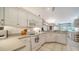 Bright kitchen with white cabinets, modern appliances, and tile floors at 626 Magellan Dr, Sarasota, FL 34243