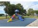 Community playground area with colorful slides, climbing structures, and a soft, cushioned ground surface at 626 Magellan Dr, Sarasota, FL 34243
