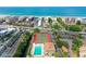 Aerial view of beachfront condo community with pool, tennis courts, and beautifully landscaped grounds at 6415 Midnight Pass Rd # 607, Sarasota, FL 34242