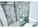Modern tiled shower with stylish fixtures and glass door, complemented by a practical toilet setup at 6415 Midnight Pass Rd # 607, Sarasota, FL 34242