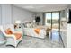 This bedroom with a private balcony is styled with cool colors and coastal decor for ultimate relaxation at 6415 Midnight Pass Rd # 607, Sarasota, FL 34242