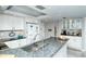 Modern kitchen with white cabinets, stainless steel appliances, and granite countertops at 6415 Midnight Pass Rd # 607, Sarasota, FL 34242