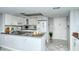 Modern kitchen with white cabinets, stainless steel appliances, and open layout at 6415 Midnight Pass Rd # 607, Sarasota, FL 34242